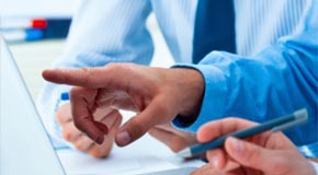 Up close picture of hands and people drafting security measures for a project