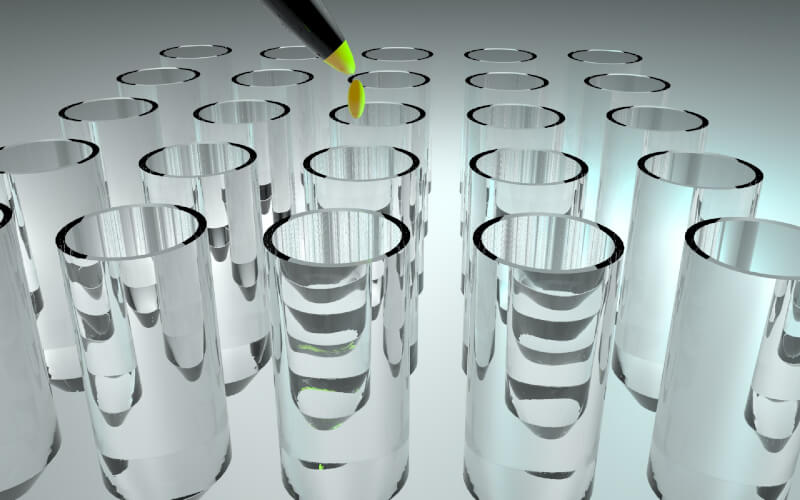 Test tubes with a yellow liquid being dripped into them