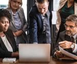 A group of business people looking at a computer